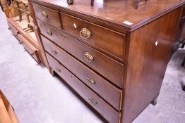 A 19th Century mahogany chest of two over three drawers having Regency style handle with brass