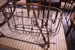 An antique wrought iron rocking crib