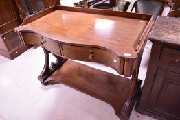 A 19th Century mahogany side or dressing table/washstand in the Regency style having serpentine