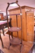 An Edwardian mahogany folding cake stand