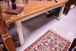 A traditional French style kitchen table having golden oak top and painted frame, approx. 200 x