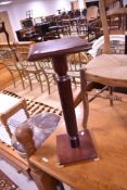 A reproduction mahogany effect jardiniere stand