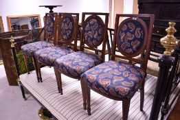 A set of four Edwardian mahogany salon chairs having later paisley upholstered seats and backs