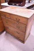 A 19th Century stripped oak chest of two over three drawers, having brushing slide/desk