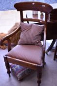 A 19th Century mahogany carver chair having scroll arm and turned legs