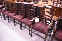 A set of six (four plus two) ladder back dining chairs upholstered in red tweed upholstery