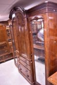 A Victorian mahogany break-front mirror door armoire