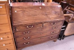 A Georgian mahogany bureau having brass drop handles and fitted interior