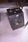 A Victorian Toleware coal purdonium with brass handle and painted decoration