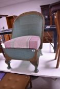 A vintage woven fibre tub chair with drawer storage under seat