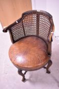 A 19th Century mahogany framed chair having bergere canework back and overstuffed leather seat on