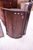 A 19th Century oak bow fronted corner cabinet, height approx. 101cm