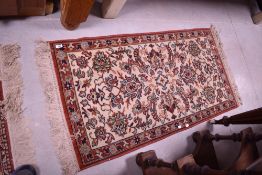 A tradtional fireside rug, approx. 130 x 70cm