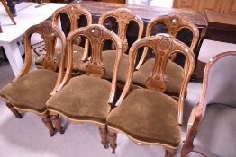 A set of six Victorian dining chairs having incised decoration , shaped frame and wide seats