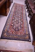 A tradtional wool carpet runner, approx. 310 x 95cm