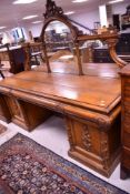 A Victorian oak mirror back sideboard of large proportion having applique decoration to doors,