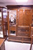 An Edwardian mahogany three piece bedroom suite comprising wardrobe, dressing table and bed frame