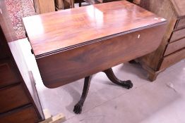 A 19th Century mahogany breakfast table having drop flaps turned column and quadruple splay legs