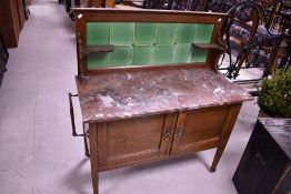A Victorian oak wash stand having marble top and tiled back