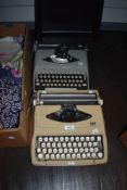 Two vintage portable typewriters, an Empire Corona de luxe and a Remington Envoy.