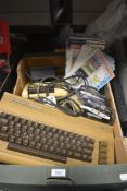 A Commadore 64 keyboard, two cassette players and a small selection of games sold along with a