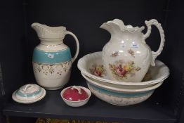 Two vintage porcelain wash bowl, jug and soap dish sets one having a floral design and the other