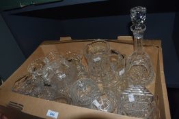 A carton of assorted cut glass and crystal items including water jugs, dessert dishes, trinket boxes