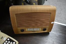 A mid-20th Century teak cased valve radio, plug and part cable removed for safety, measuring 30cm