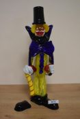 A vintage Murano glass clown figure, of typical form with oversized bow tie and holding a cane,