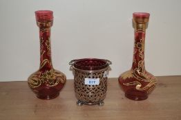 A pair of 19th/20th Century Bohemian ruby glass vases, hand painted with a gilt foliate design and