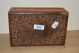 A 20th Century Indian carved wooden jewellery box with wire inlay to the vacant oval cartouche on