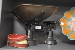 A set of black painted scales and weights, measuring 32cm long