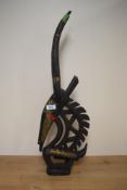 An African carved hardwood study of an antelope with gilt metal mounts, measuring 60cm high