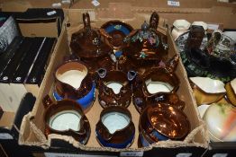 Two copper lustre teapots and six copper lustre jugs etc.