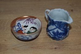 A 19th Century blue and white porcelain miniature jug, measuring 5cm, and a Chinese polychrome