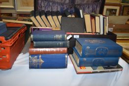 A suitcase containing various books of sporting interest including cricket, titles including '