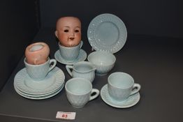 A 20th Century light blue glazed doll's tea set decorated in a lozenge design, together with two