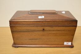 A 19th century figured mahogany tea caddy, of sarcophagus form, the hinged cover lifting to reveal