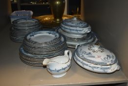 An assortment of blue and white dinner ware having foliate design including tureens, dinner