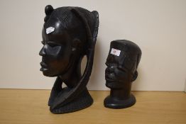 Two African carved-hardwood busts, the larger with elaborate braids, the smaller with incised