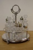 A silver-plate and cut-glass cruet set, containing salt cellar, peperette, mustard, vinegar and