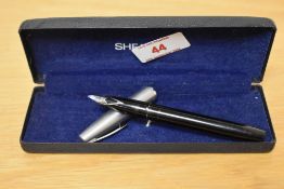 A Sheaffer USA cartridge fill fountain pen and in black with white spot to the brushed metal cap