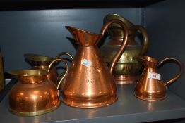 Two 20th century copper measures, of traditional design, and sold together with three copper and