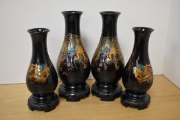 Two pairs of Chinese lacquered style baluster vases, with gilt and polychrome depictions of dragons,