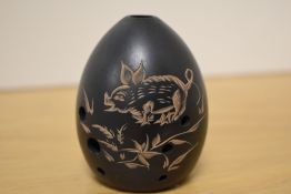 A Chinese pottery egg-shaped Xun Ocarina flute musical instrument, incised decoration of a piglet