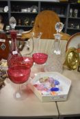 A cut cranberry style glass decanter sold along with three cranberry style glasses as well as two
