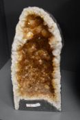 A large geode rock formation, most likely heat treated amethyst with the appearance of citrine, 45cm