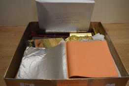 A box of gilding tools and materials including a gilder's cushion, samples of bole and gesso work,