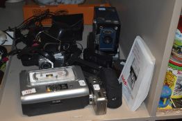 An assortment of vintage cameras including a Kodak EasyShare printer dock series 3.