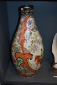 A large Japanese Imari porcelain floor vase, of baluster form, decorated with a large panel of a